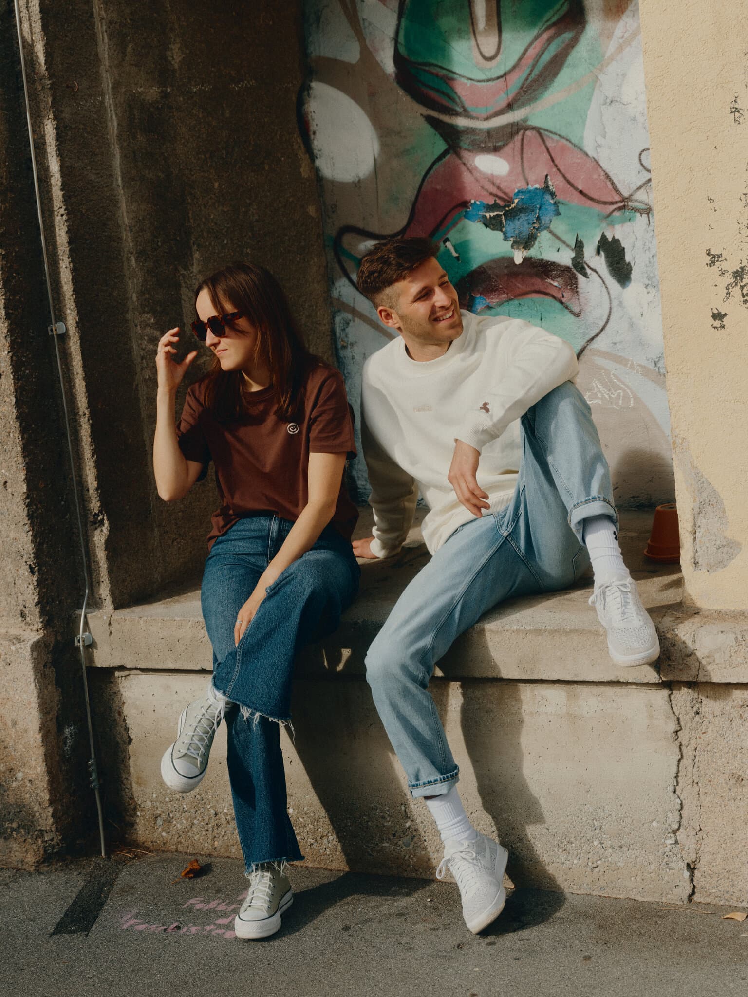 Two people outside with embroidered clothes